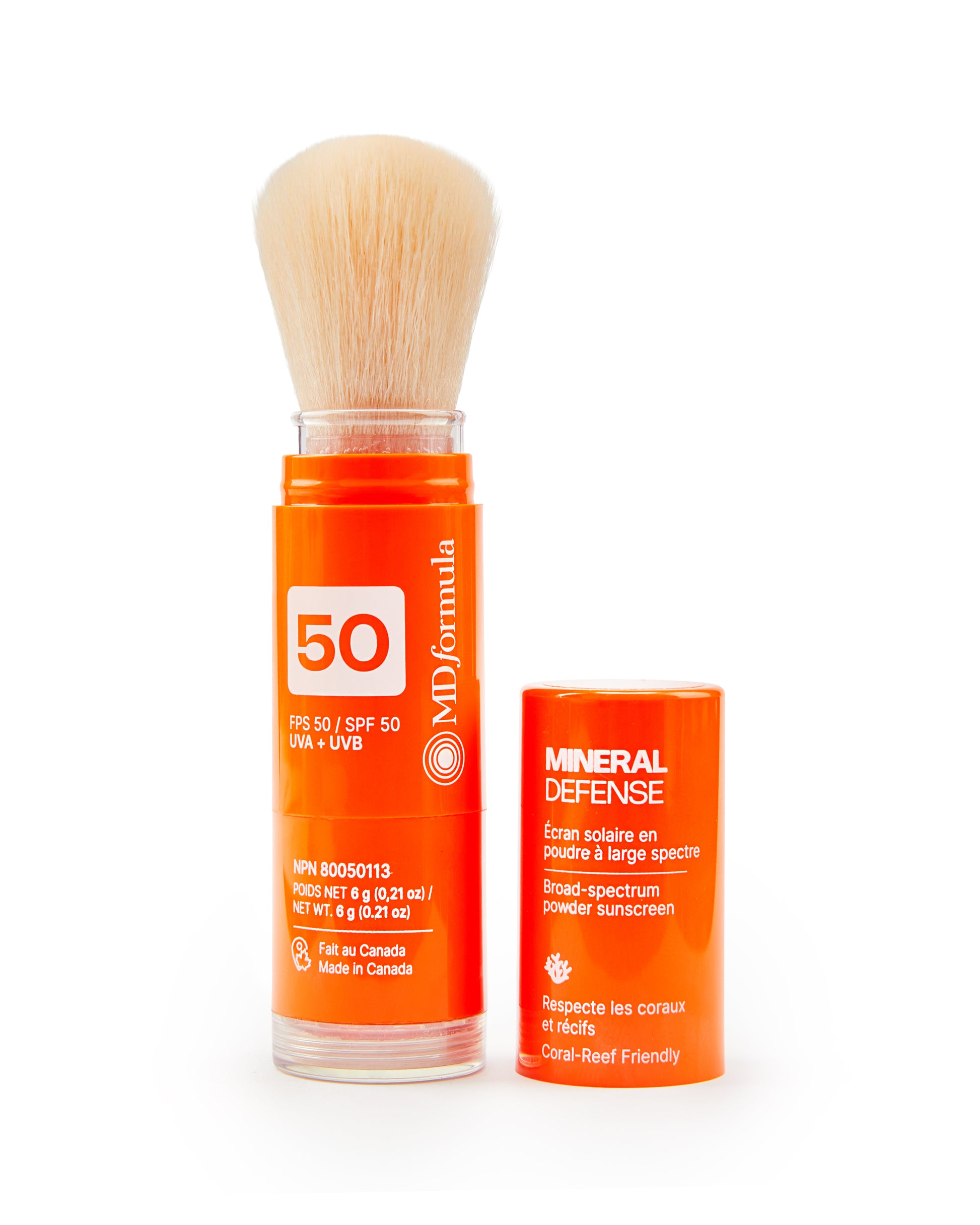 Orange skincare product with brush and 'Mineral Defense' label on a white background